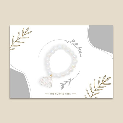 A white rakhi with a cute bunny charm.