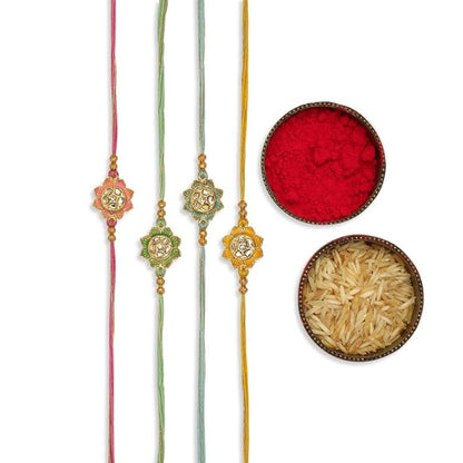 Three rakhi's with gold and pink beads, symbolizing love and protection. Red powder with bowl of rice, representing auspiciousness.