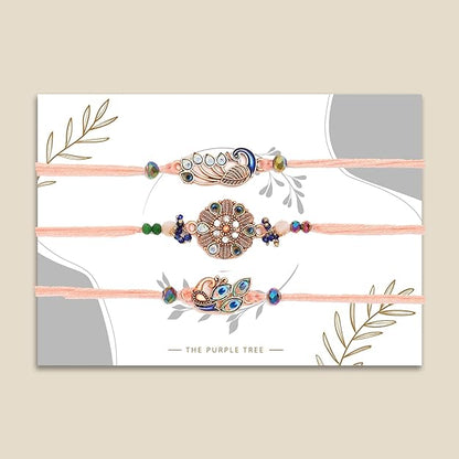 Three colorful rakhi's with flower and peacock design.