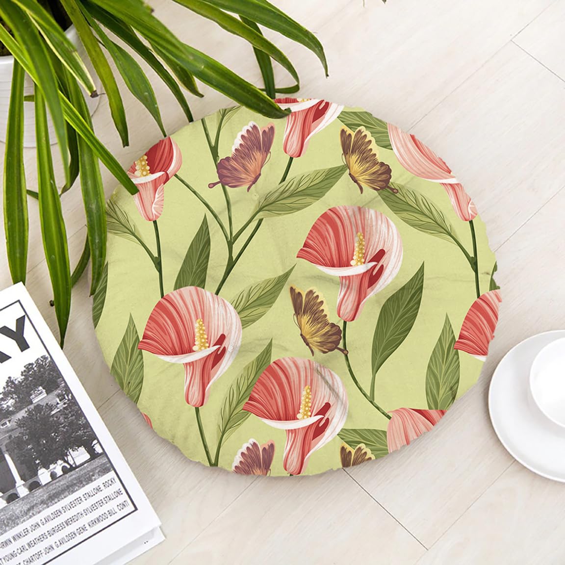 A round floor mat featuring a vibrant floral pattern in various colors.