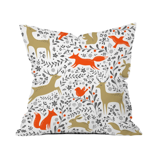 A white pillow featuring playful orange and brown foxes alongside charming birds in a whimsical design.

