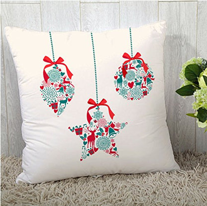 Three colorful Christmas ornaments resting on a soft white pillow, creating a festive and cozy holiday atmosphere.
