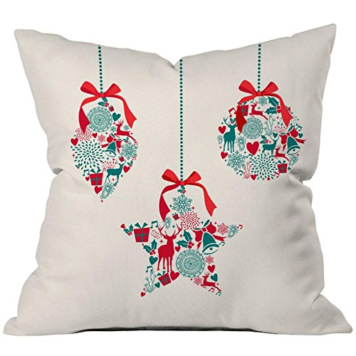  A trio of vibrant Christmas ornaments displayed on a plush white pillow, enhancing the seasonal decor with elegance.

