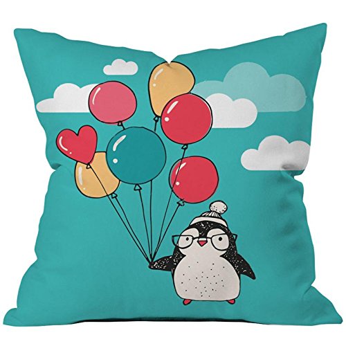 A whimsical pillow design showcasing a penguin with vibrant balloons.