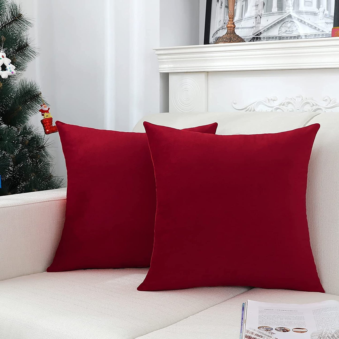 Two red pillows on a couch complement the nearby Christmas tree, creating a welcoming and festive environment.