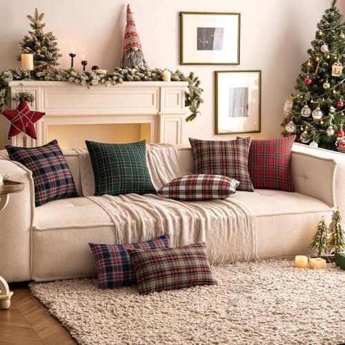 Two red plaid pillows on a couch complement the cheerful Christmas tree nearby, adding a festive touch to the room.