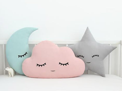 2. Decorative pillows with cloud, star, and moon motifs.