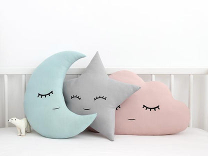 3. Pillows adorned with cloud, star, and moon patterns.