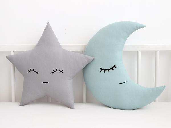 4. Cute pillows with cloud, star, and moon illustrations.