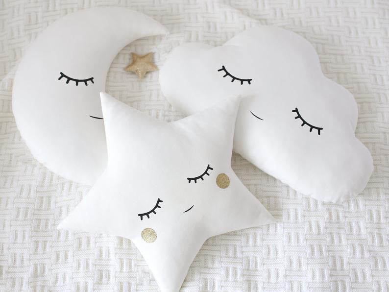 2. Decorative pillows with cloud, star, and moon motifs.