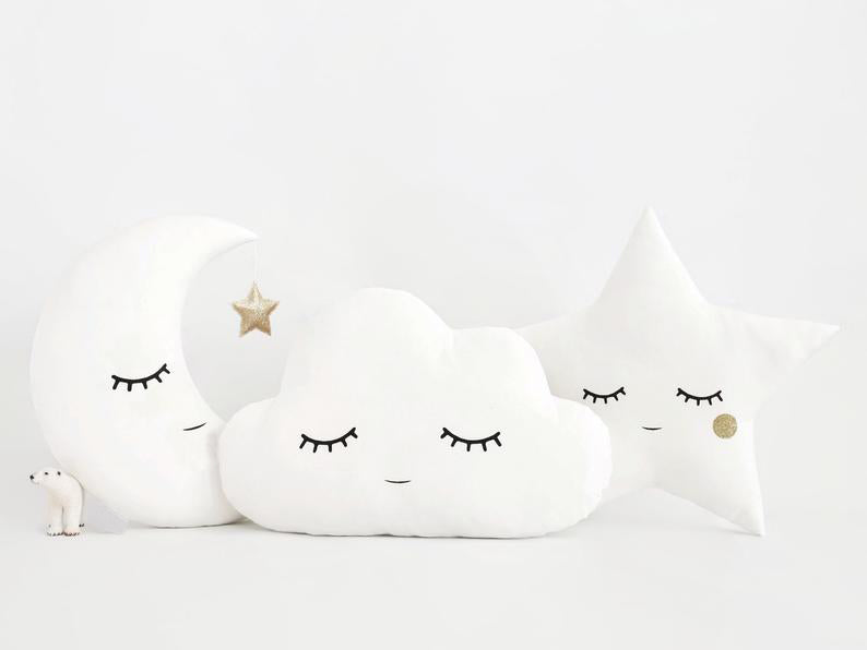 1. Three pillows featuring a cloud, star, and moon designs.