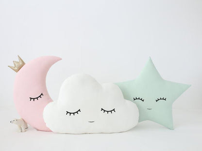 Three pillows with a moon and cloud design, adding a touch of celestial charm to any space.