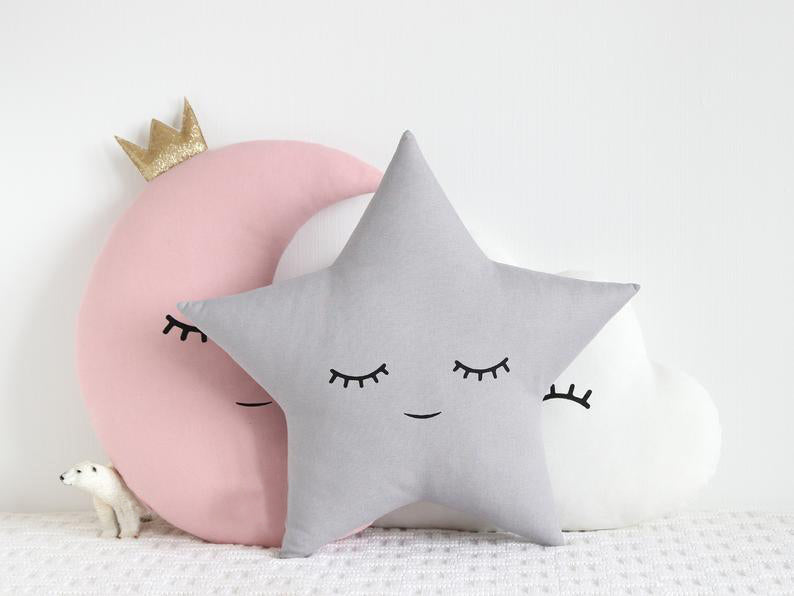Three decorative pillows featuring a moon and cloud design, perfect for adding a touch of whimsy to any room.