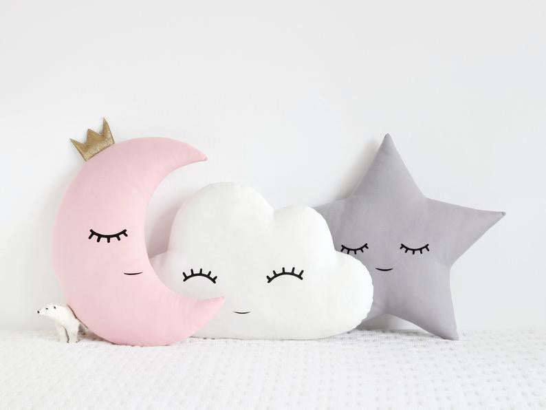 Three pillows featuring a moon and cloud design.