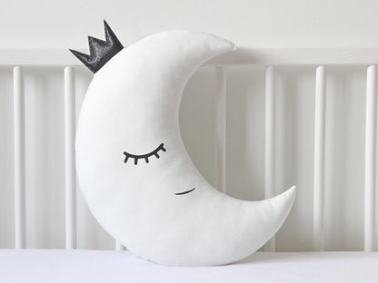 Decorative pillows in the shape of stars and a moon, white and blue in color.