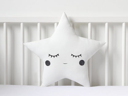 Moon and star pillows in white and blue colors, adding a celestial touch to the room.