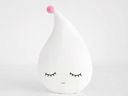 A cute white pillow with eyes and a yellow dot, perfect for adding a touch of whimsy to your home decor.