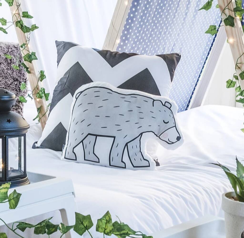 A cozy pillow featuring a cute bear. Perfect for snuggling up and adding a touch of cuteness to any room.