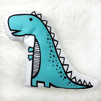 A decorative pillow featuring a dinosaur design, perfect for adding a fun touch to any room decor.