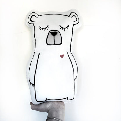 A white bear pillow with a heart drawn on it, perfect for cuddling and adding a touch of love to any space.