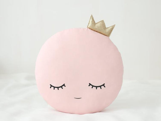 A regal pillow adorned with a crown, adding a touch of royalty and elegance to any space.