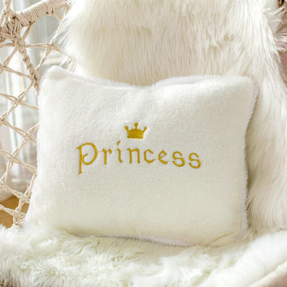 White pillow with "princess" in elegant cursive script.