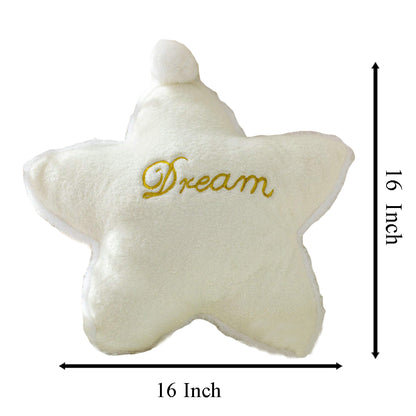 A white pillow with the word "dream" written on it, providing a cozy and inspirational touch to any bedroom decor.