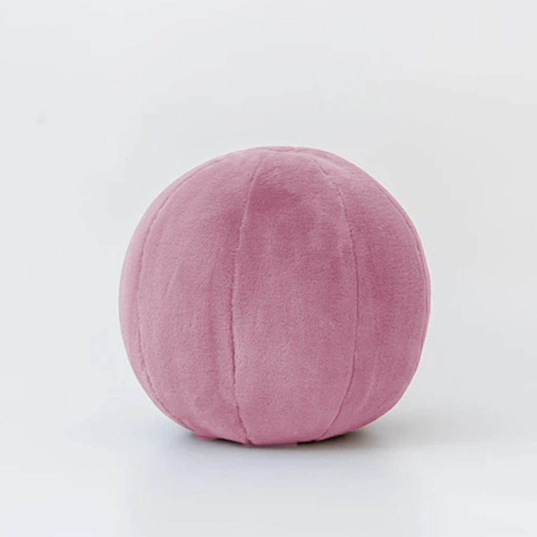 A vibrant assortment of balls scattered on a clean white floor, creating a playful and colorful scene.