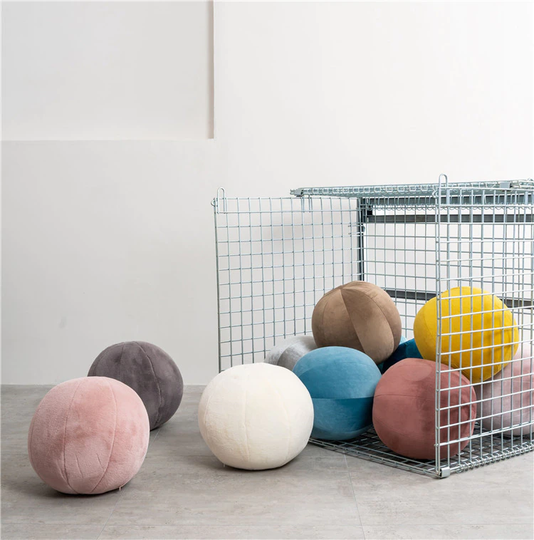 Colorful spheres on bright white floor.