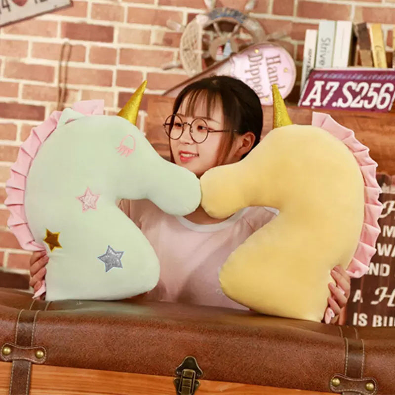Cute pink unicorn head pillow adorned with stars, a charming addition to any cozy space.