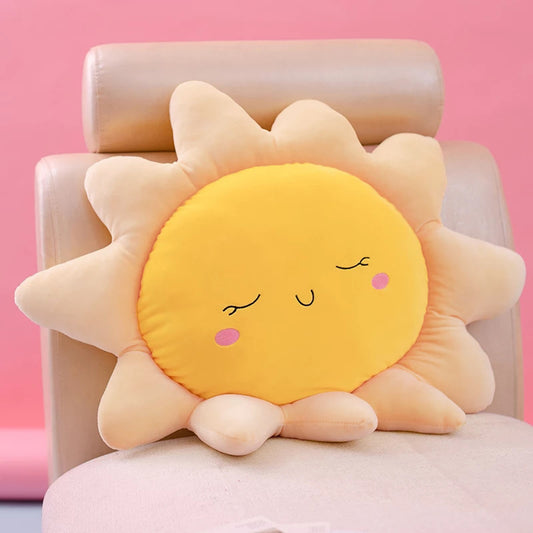 Smiley face sun pillow on chair.