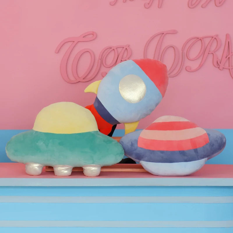 Pink and blue stripes on a unique Saturn-shaped pillow.
