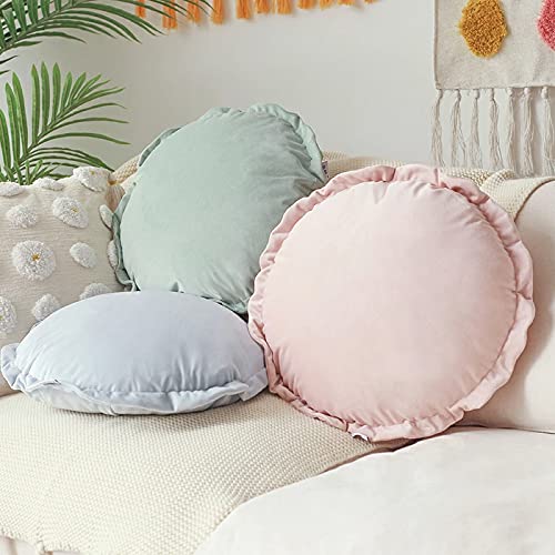 Assorted round pillows with different hues on a bed.