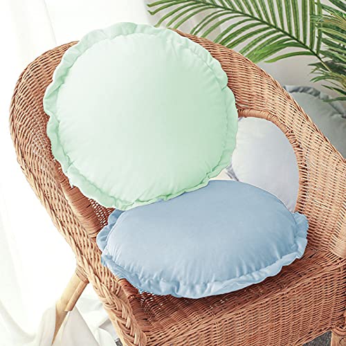  Four colorful round pillows arranged neatly on a bed.