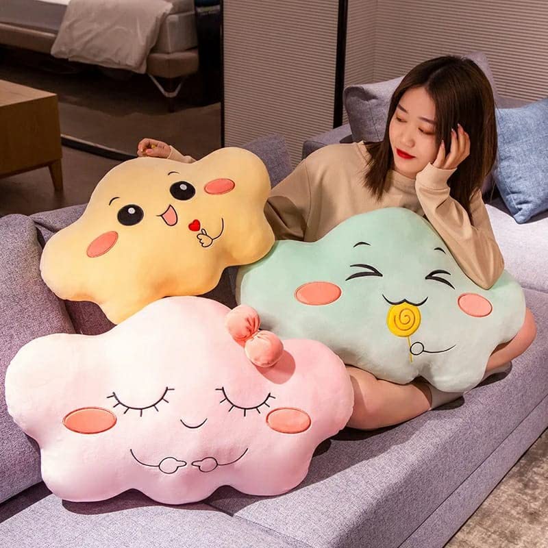  A cute pillow with a smiling cloud face holding a lollipop.
