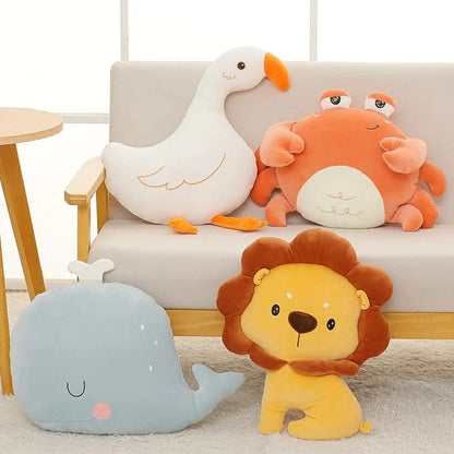 A lion relaxes on a chair with a tiny stuffed animal nearby.