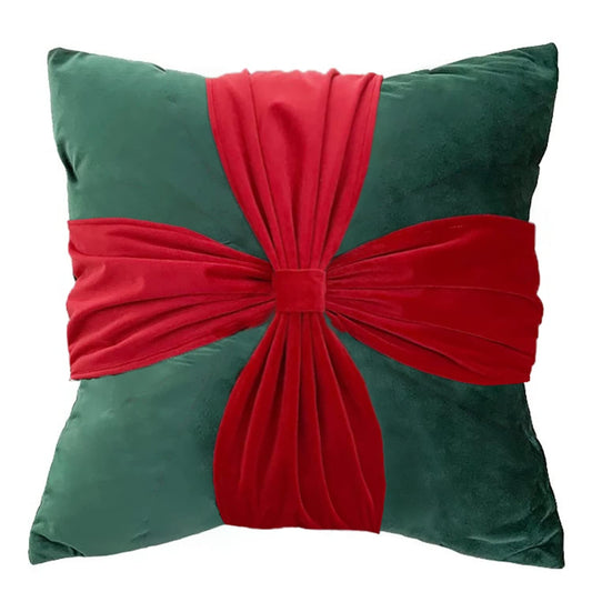  A festive green and red pillow with a red bow, perfect for adding a touch of holiday cheer to your home decor.