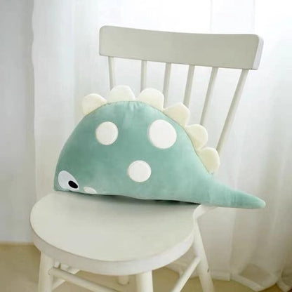 A cute stuffed dinosaur toy sitting on a desk, ready to bring joy and playfulness to anyone who sees it.