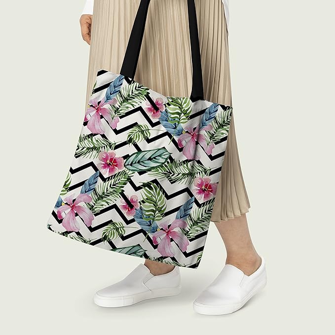tote bag with a colorful tropical design and chic black straps.