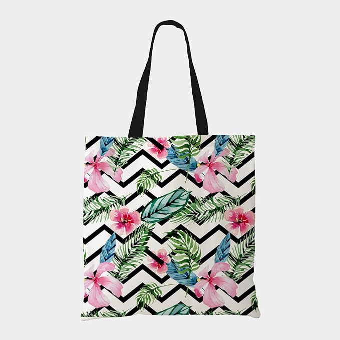 A tote bag featuring a vibrant tropical print and sleek black handles.