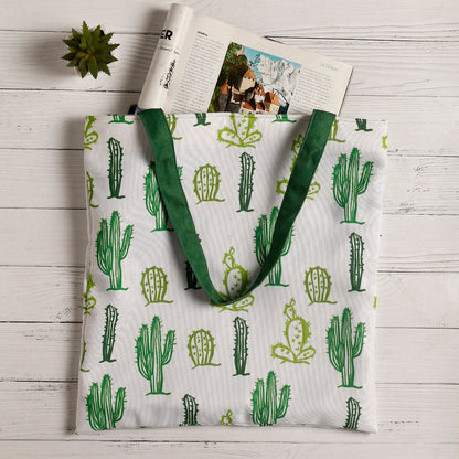 Stylish green and white tote bag featuring a trendy cactus design, ideal for a casual day out.