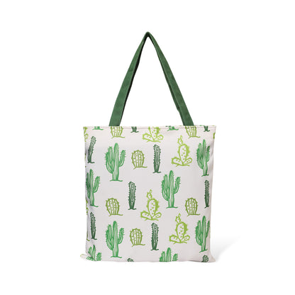 Fashionable green and white tote bag with a fun cactus pattern, great for adding a pop of color to your outfit.