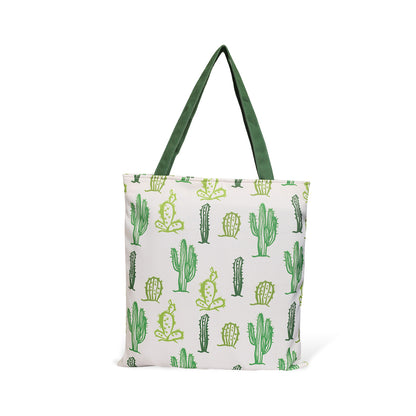 Trendy green and white tote bag decorated with a whimsical cactus print, a stylish choice for any occasion.