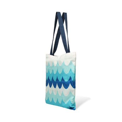 Side view of Stylish blue and white tote bag with a wave pattern, ideal for a day by the water or running errands.