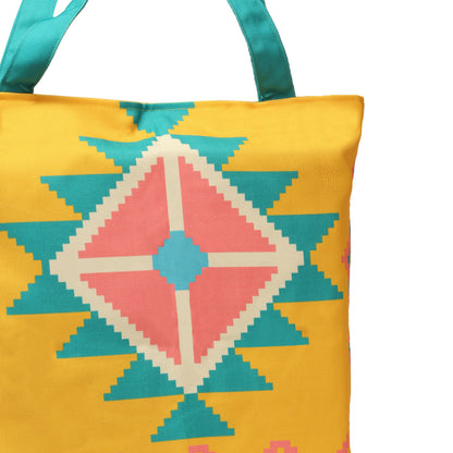 A vibrant yellow and blue tote bag featuring a delightful pink and turquoise design. Perfect for adding a pop of color to any outfit.