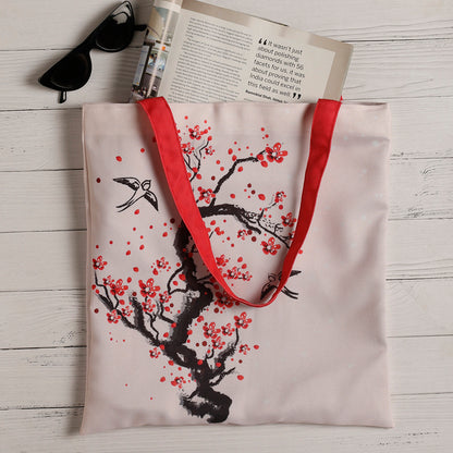 Chic tote bag adorned with delicate cherry blossoms, ideal for adding a touch of elegance to your outfit.