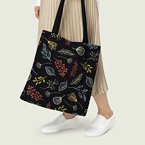 Women Holding Stylish black tote with colorful floral and leaf pattern.