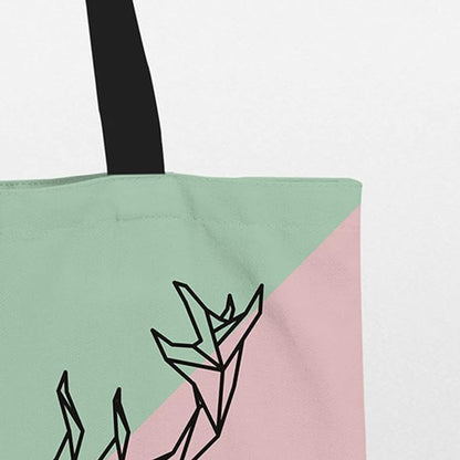 A stylish tote bag in pink and green with a deer head design. Perfect for adding a touch of nature to your outfit.