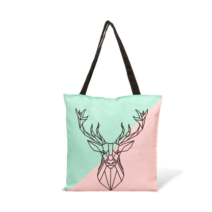 Deer head pattern on pink and green tote bag.