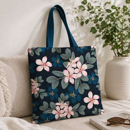 Floral-patterned tote bag on a couch with a plant in the background